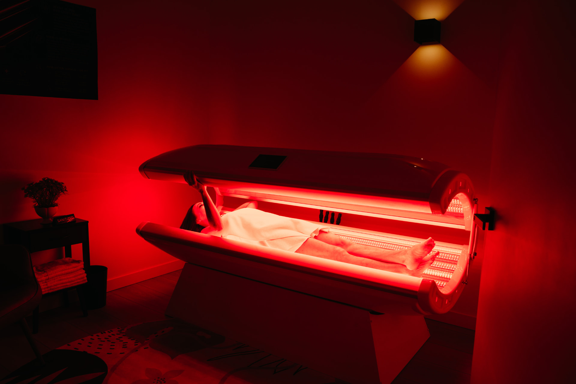 A member relaxing in the red light therapy bed at Recharge